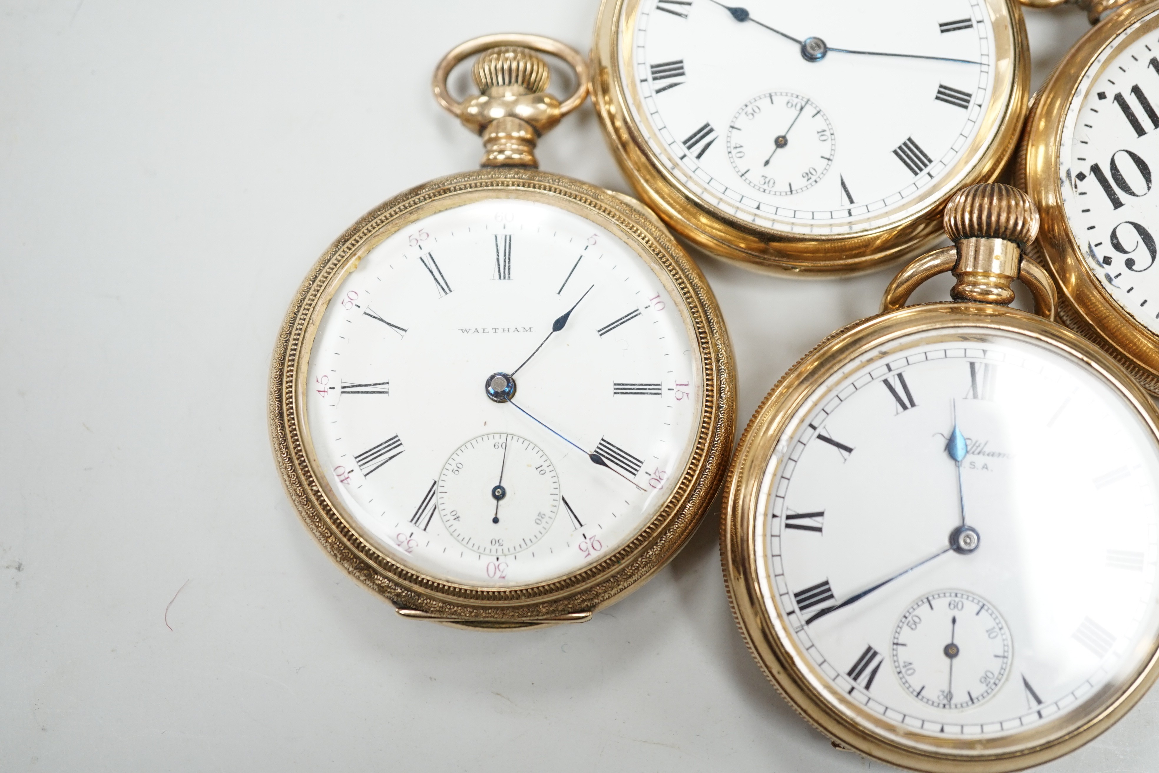 Three assorted gold plated Waltham open faced pocket watches and a similar Elgin pocket watch.